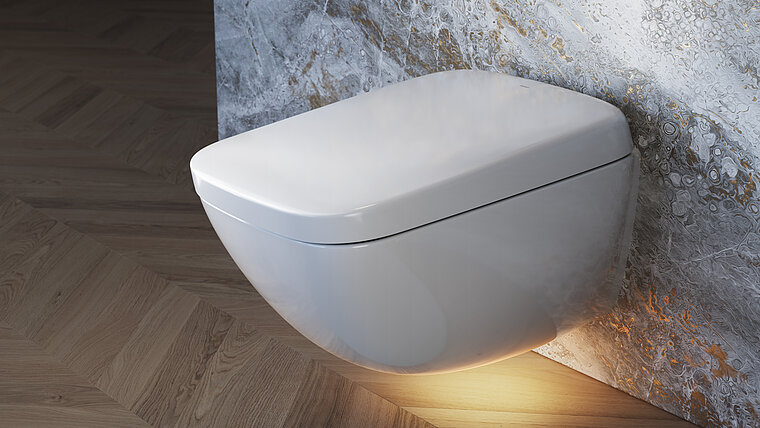 Das Bild zeigt das elegante, wandhängende NEOREST WX von TOTO, welches sich durch sein glattes, weißes Design hervorhebt, montiert an einer Wand mit einer auffälligen Marmoroptik. Die Toilette wird durch ein warmes, indirektes Licht von unten beleuchtet, was die moderne Ästhetik des Produktes unterstreicht und eine luxuriöse Atmosphäre schafft.