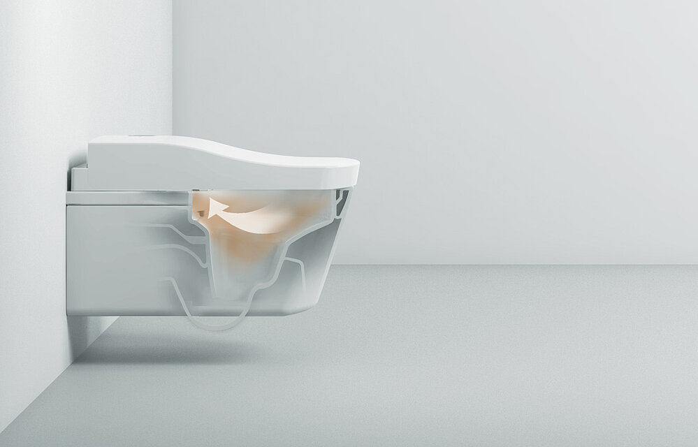 L'image montre des toilettes avec un washlet. Elle est transparente au milieu, de sorte que l'on peut voir à l'intérieur. Un nuage brun est représenté à l'intérieur et une flèche blanche indique que l'air est aspiré dans le washlet.