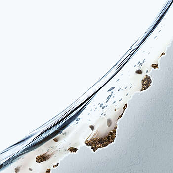 The picture shows a close-up of a ceramic. The surface of the ceramic has some areas that are rough rather than smooth. There are brown deposits in these areas. 